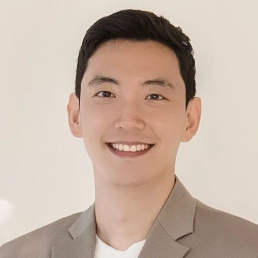 Mintak Son, smiling in a light-colored jacket